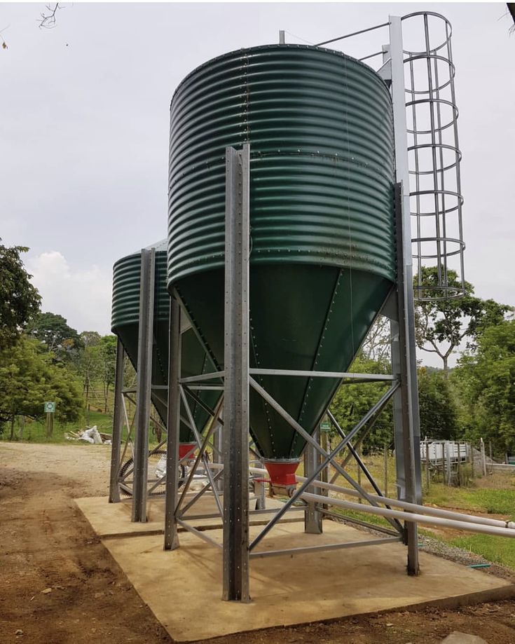 Deux silos métalliques verts sur une structure de support